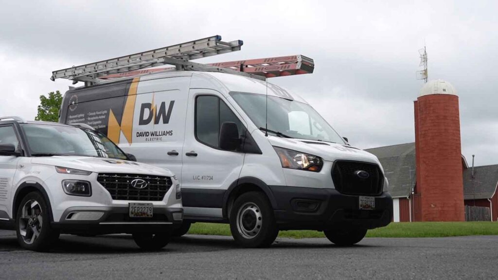 David Williams Electric work vans in front of a local Frederick, MD landmark. (Manning Media Red Silo)