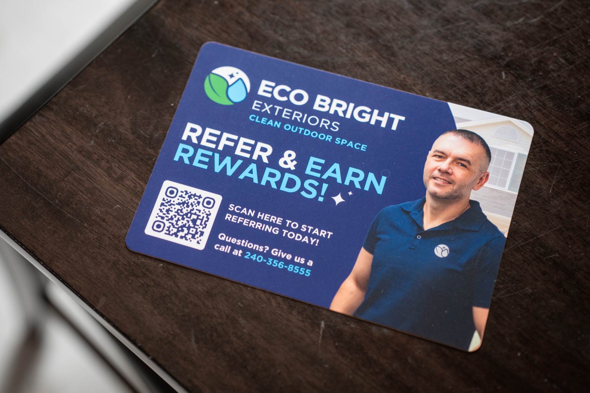 Eco Bright Exteriors refer-and-earn rewards card with QR code and phone number